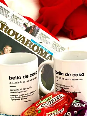 a table with two coffee mugs and a newspaper at Gemelli-San Pietro-Trastevere-casa con posto auto in Rome