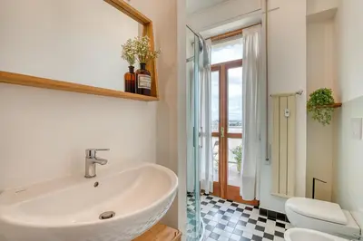 a bathroom with a sink and a toilet and a mirror at Matilde's view apartment Saint Peter in Rome