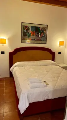 a bedroom with a bed with two towels on it at Villette Aldobrandeschi Urban Oasis Vacation Homes in Rome