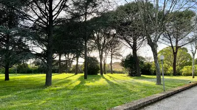 a park with trees and grass and a street sign at Villette Aldobrandeschi Urban Oasis Vacation Homes in Rome