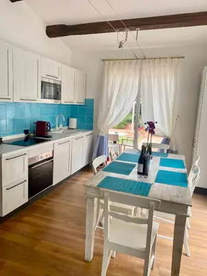 a kitchen with a table and a kitchen with blue tiles at Villette Aldobrandeschi Urban Oasis Vacation Homes in Rome