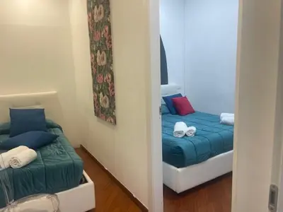 a small room with a bed and a mirror at Appartamento int 1 in Rome