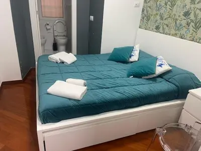 a bed with blue sheets and white towels on it at Appartamento int 1 in Rome