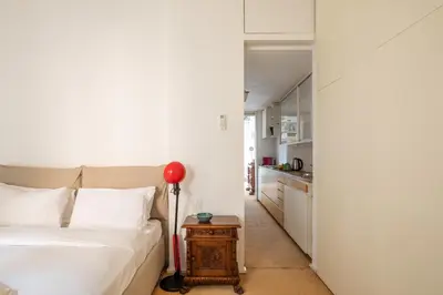 a bedroom with a bed and a table with a lamp at iFlat The Carpet Apartment in Rome