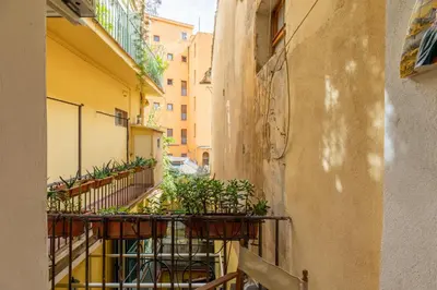 an alley with plants on the balcony of a building at iFlat The Carpet Apartment in Rome