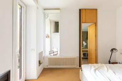 a bedroom with a bed and a window and a door at iFlat The Carpet Apartment in Rome
