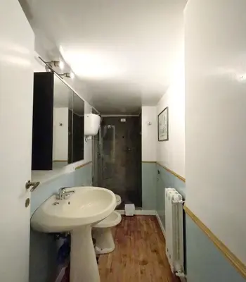 a bathroom with a white sink and a shower at Navona Gold Apartment in Rome