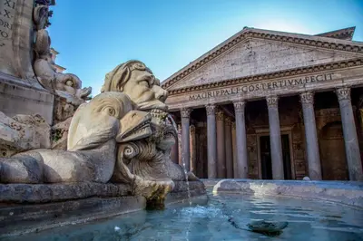 a statue in front of a fountain in front of a building at Navona Gold Apartment in Rome