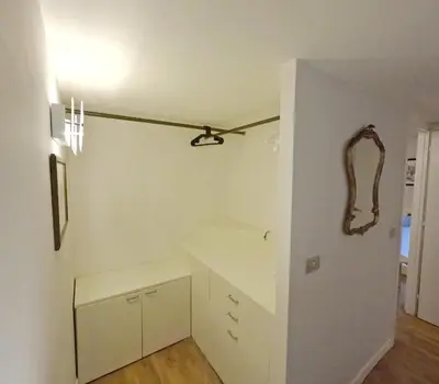a kitchen with white cabinets and a ceiling at Navona Gold Apartment in Rome