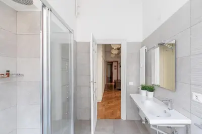 a white bathroom with a shower and a sink at iFlat The gem of the center in Rome