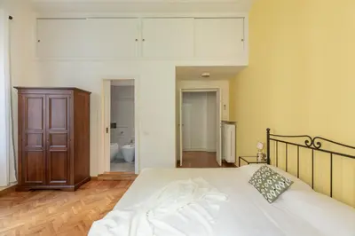 a bedroom with a large bed and a bathroom at iFlat The gem of the center in Rome