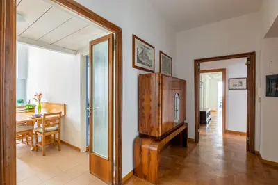 a living room with a wooden cabinet and a table at iFlat The gem of the center in Rome