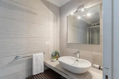 a white bathroom with a sink and a mirror at iFlat The gem of the center in Rome
