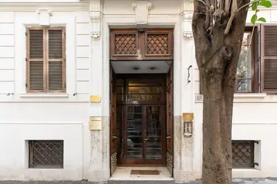 a door in a white building with a tree at iFlat The gem of the center in Rome