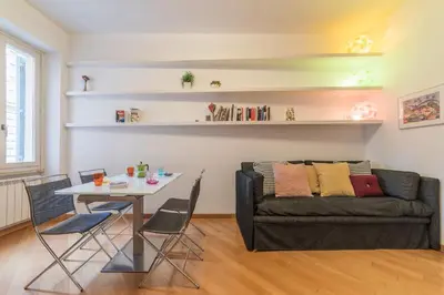 a living room with a table and a couch at iFlat Apê Ponte Sisto in Rome