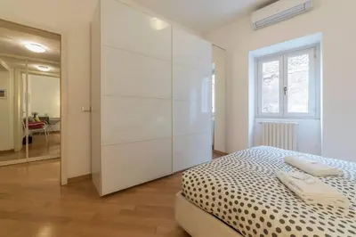 a bedroom with a large white closet and a bed at iFlat Apê Ponte Sisto in Rome