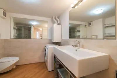 a white bathroom with a sink and a toilet at iFlat Apê Ponte Sisto in Rome
