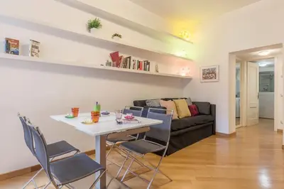 a living room with a table and chairs and a couch at iFlat Apê Ponte Sisto in Rome