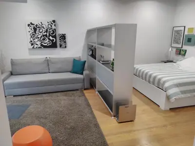 a living room with a bed and a couch at Garden house in Rome