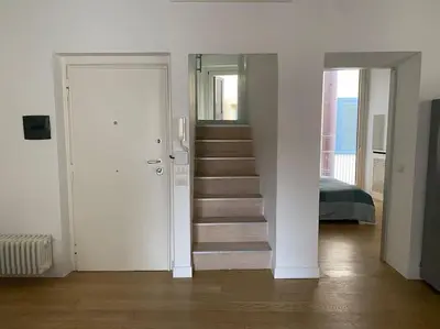 a white room with a staircase leading to a bedroom at Pantheon Design Apartment in Rome