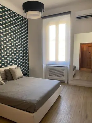 a bedroom with a large bed and a window at Trastevere Design Apartment in Rome