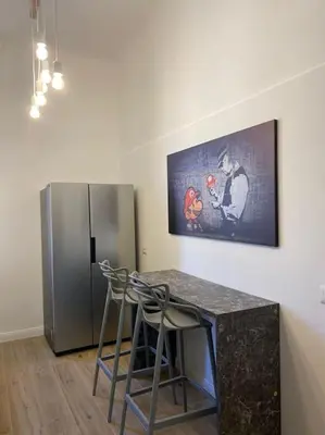 a kitchen with a counter and a refrigerator at Trastevere Design Apartment in Rome