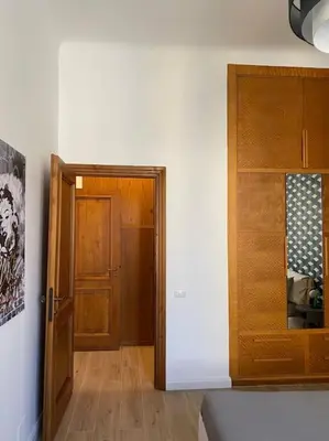 a hallway with a wooden door and a wooden cabinet at Trastevere Design Apartment in Rome