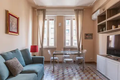 a living room with a couch and a table at GuestHost - Bright APT - San Pietro & Castel Sant'Angelo in Rome