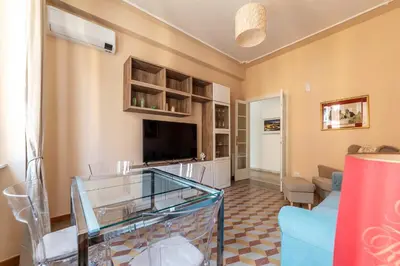 a living room with a couch and a television at GuestHost - Bright APT - San Pietro & Castel Sant'Angelo in Rome