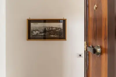 a picture hanging on a wall next to a door at GuestHost - Bright APT - San Pietro & Castel Sant'Angelo in Rome