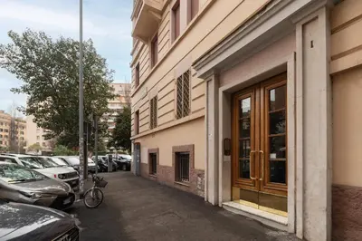 a bike parked next to a building with parked cars at GuestHost - Bright APT - San Pietro & Castel Sant'Angelo in Rome