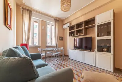 a living room with a couch and a tv and a table at GuestHost - Bright APT - San Pietro & Castel Sant'Angelo in Rome