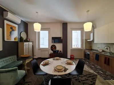 a kitchen and living room with a table and chairs at Amina's House Lab in Rome