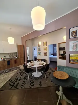 a dining room and kitchen with a table and chairs at Amina's House Lab in Rome