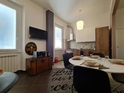 a kitchen and dining room with a table and chairs at Amina's House Lab in Rome