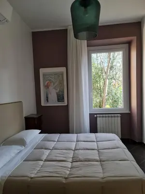 a bedroom with a large bed and a window at Amina's House Lab in Rome