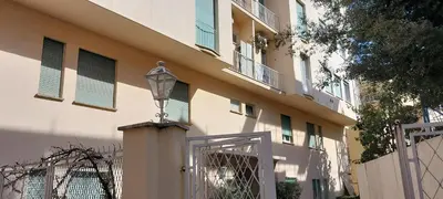 a building with a street light next to a gate at Pariolina in Rome