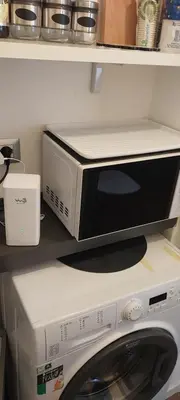 a microwave sitting on top of a washing machine at Pariolina in Rome