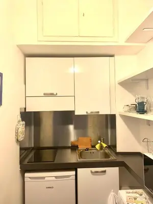 a kitchen with white cabinets and a sink at Pariolina in Rome