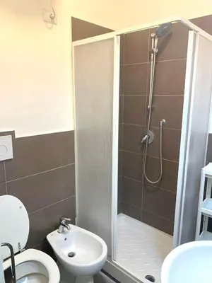 a bathroom with a shower and a toilet and a sink at Pariolina in Rome