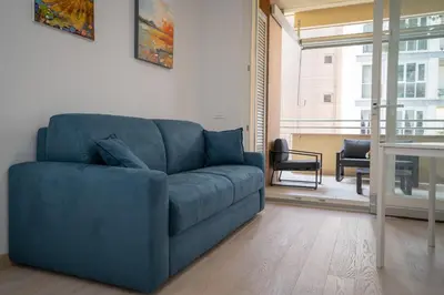 a blue couch sitting in a living room at Ancient Rome Apartment in Rome