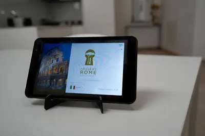 a tablet on a table with a sign on it at Ancient Rome Apartment in Rome