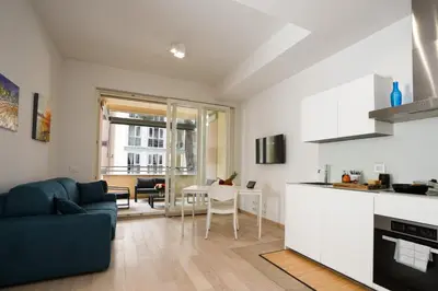 a kitchen and living room with a couch and a table at Ancient Rome Apartment in Rome