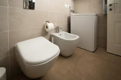 a bathroom with a white toilet and a bidet at Ancient Rome Apartment in Rome