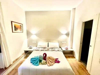 a bedroom with a bed with bows on it at Vatican Suite 