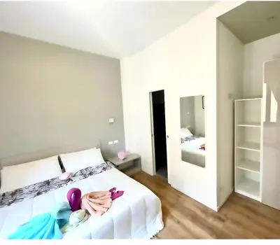 a bedroom with a white bed with a towel on it at Vatican Suite 