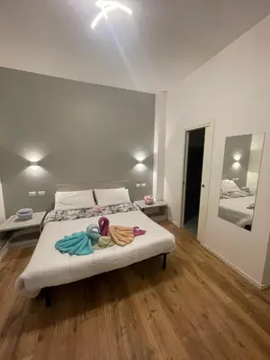 a bedroom with a bed with towels on it at Vatican Suite 