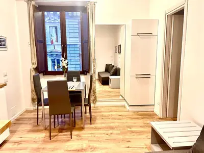 a dining room and living room with a table and chairs at Vatican Suite 