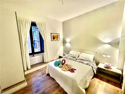a bedroom with a bed with two towels on it at Vatican Suite 