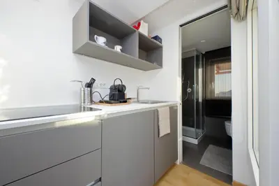a white kitchen with a sink and a toilet at Beautiful Loft in Ponte Milvio with terrace in Rome